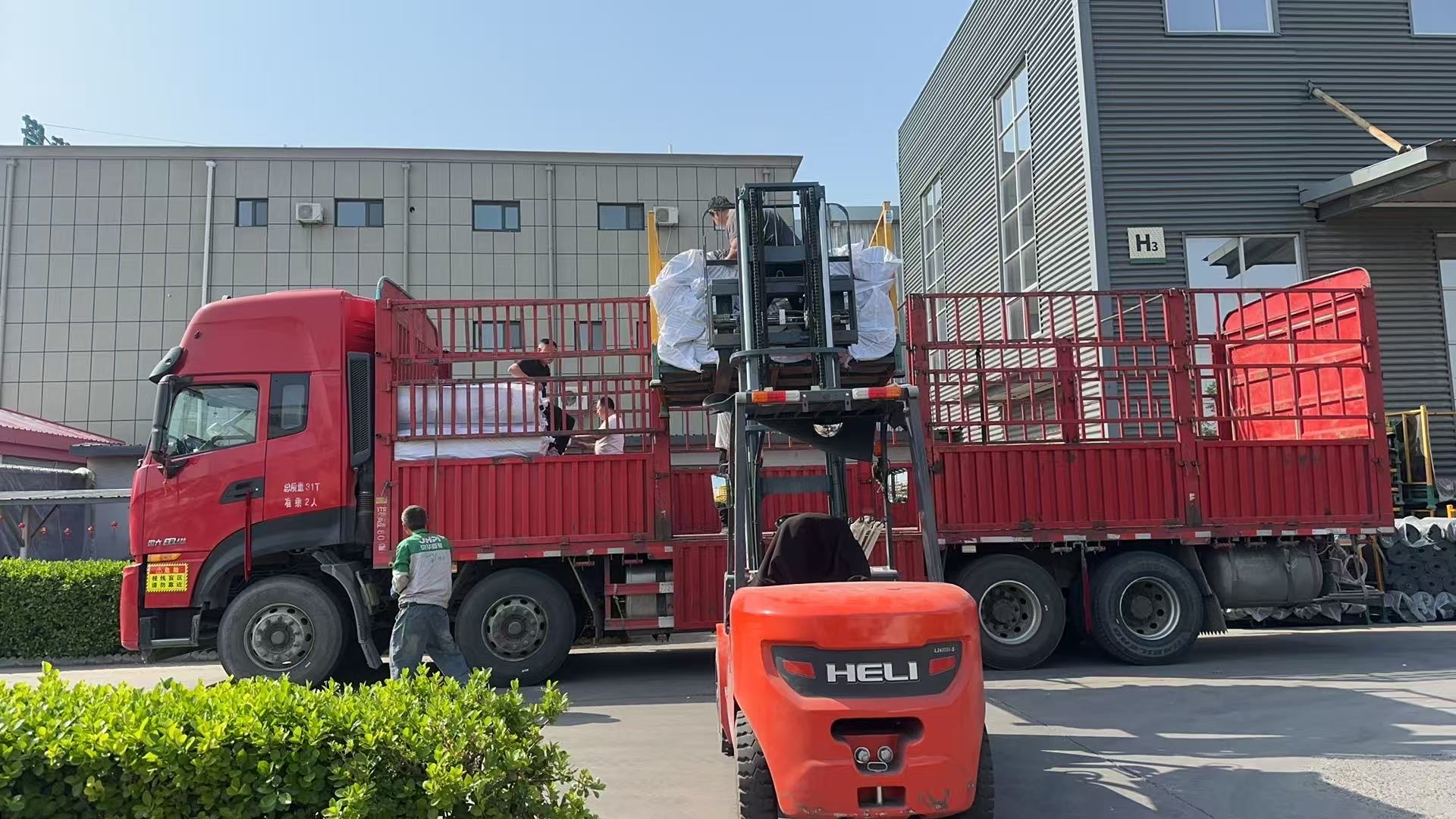 Forklift loading packed rolls onto truck